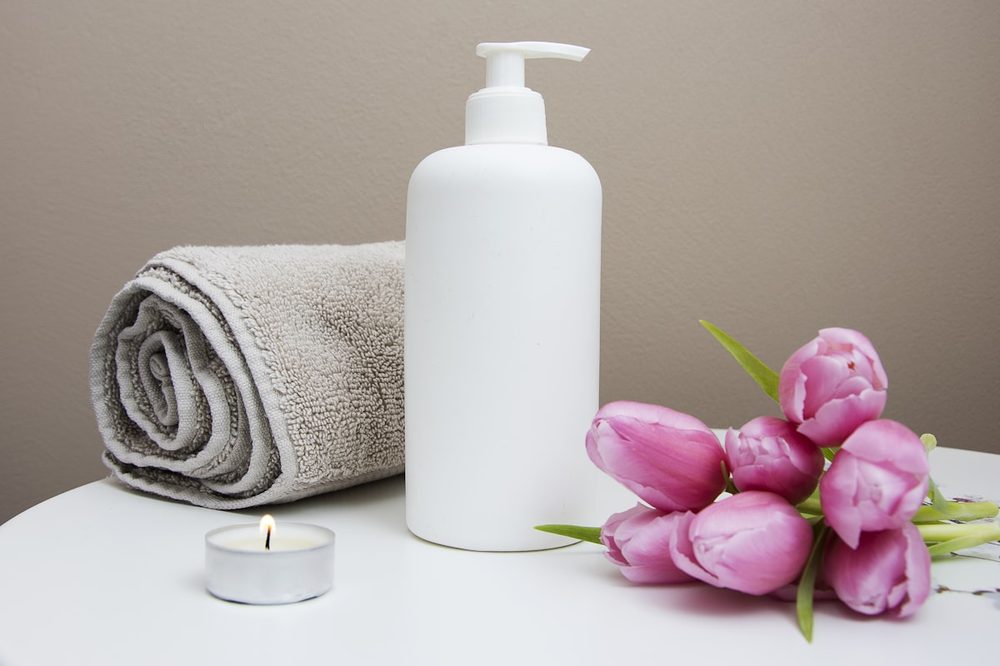 Fresh towels, lotion, and flowers in a calm treatment room